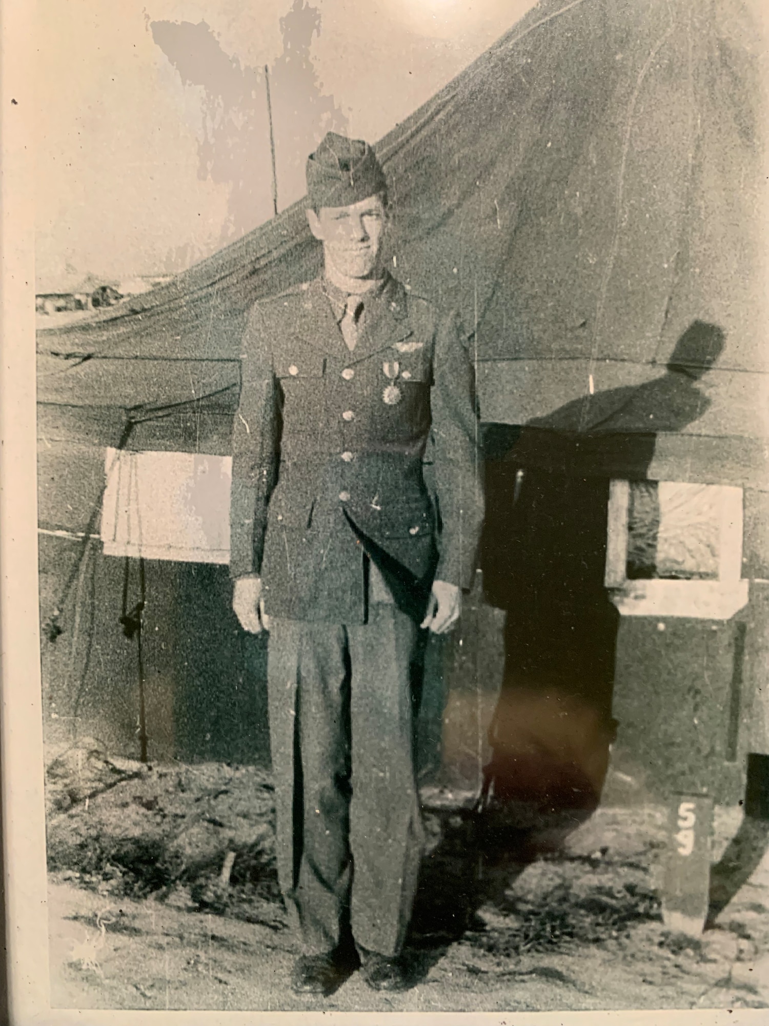A service member in World War II poses for a photo.