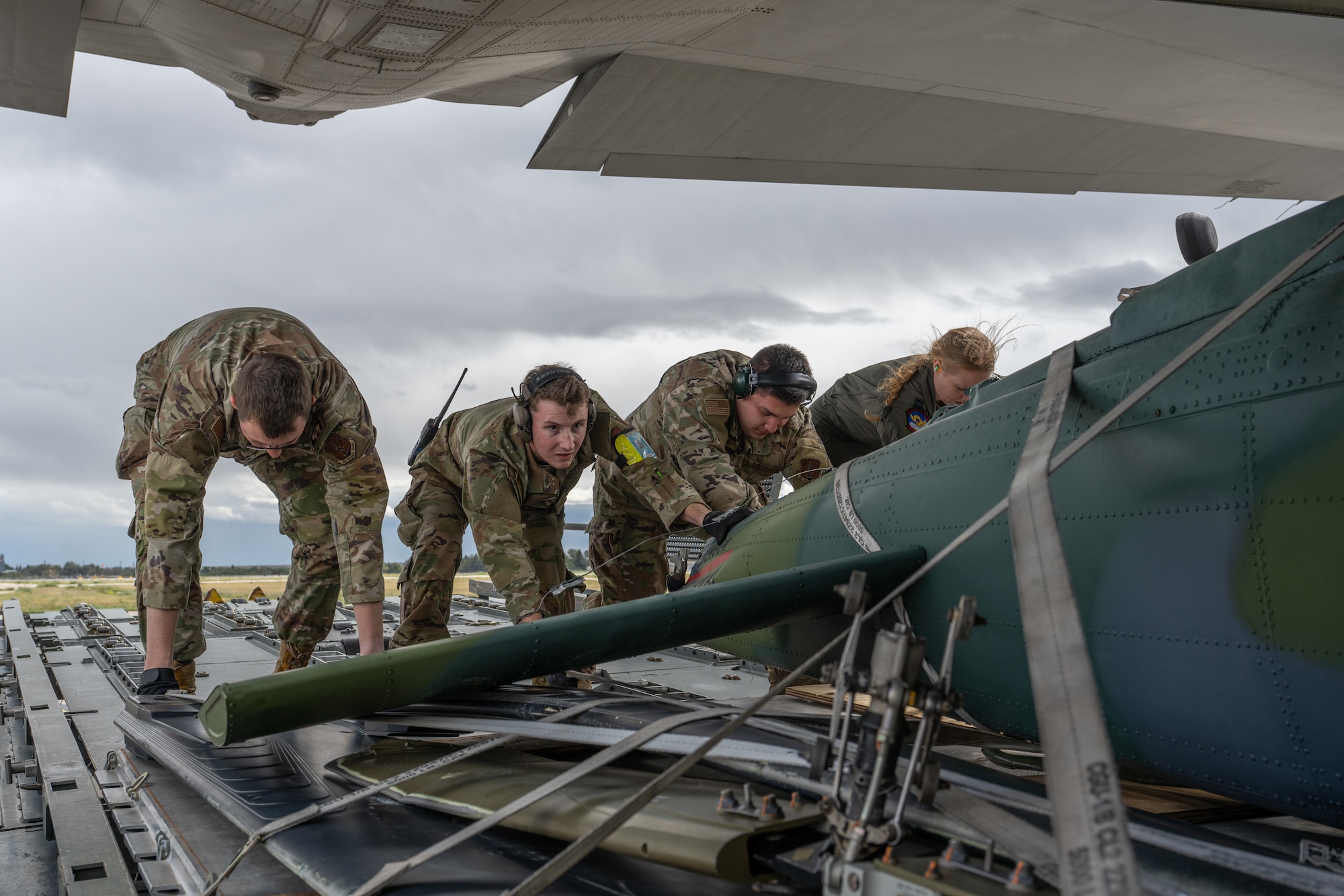 U.S. Air Force Airmen from the 153rd Airlift Wing’s Logistics Readiness Squadron work alongside aircrew and loadmasters from the 317th Airlift Wing to load a UH-1 helicopter onto a C-130J Super Hercules at Wyoming Air National Guard Base in Cheyenne, Wyo., Sept. 17, 2025. The 317th AW transported the helicopter back to Dyess Air Force Base, Texas where it will be used to support aircraft mishap response and recovery training at the 436th Training Squadron’s crash lab. (U.S. Air Force photo by Airman 1st Class Caleb Schellenberg)