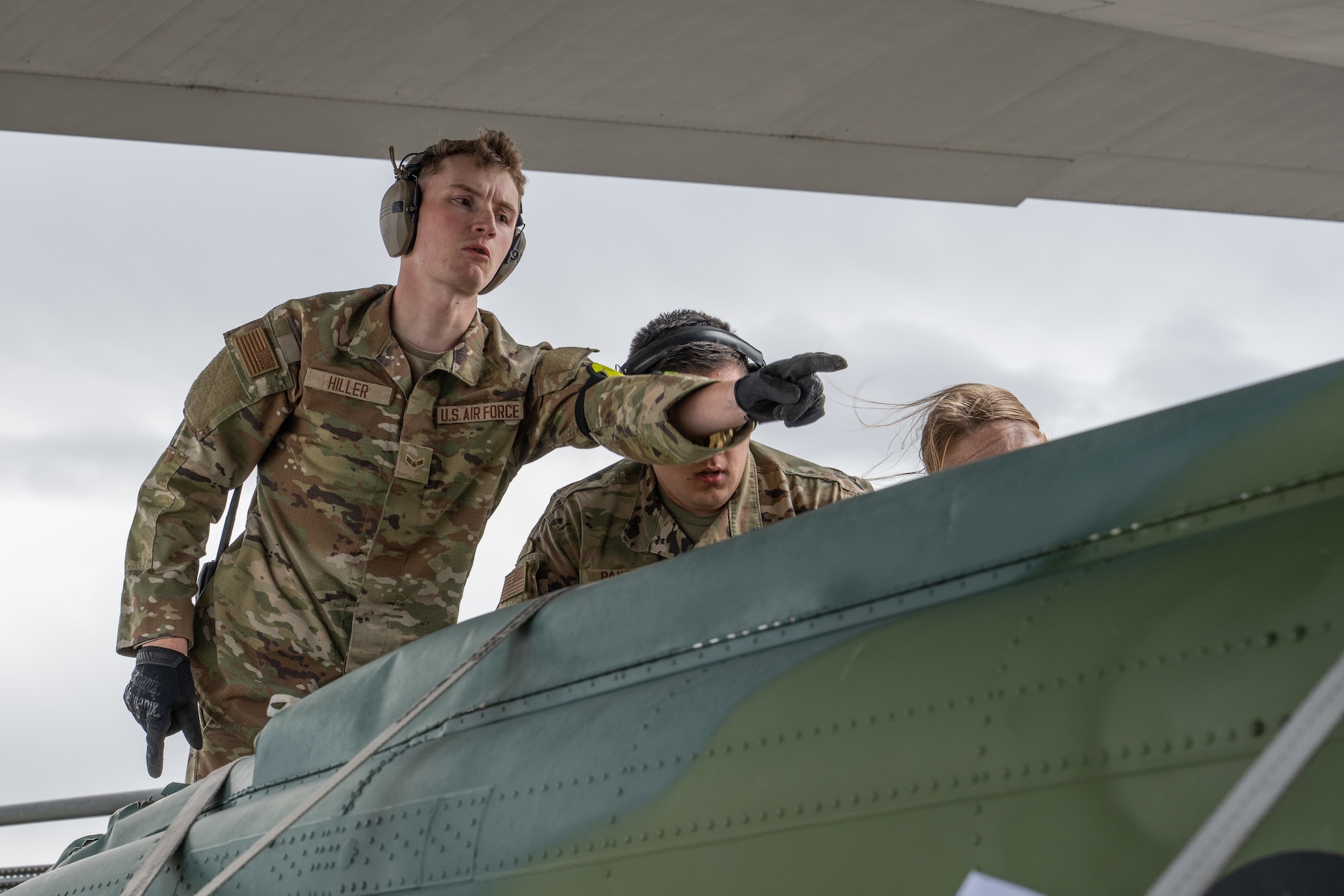U.S. Air Force Airman 1st Class Nathaniel Hiller, 153rd Logistics Readiness Squadron air transportation specialist, assists with loading a UH-1 helicopter onto a C-130J Super Hercules from the 317th Airlift Wing, Dyess Air Force Base, Texas, at Wyoming Air National Guard Base in Cheyanne, Wyo., Sept. 17, 2025. The 317th AW transported the helicopter back to Dyess where it will be used to support aircraft mishap response and recovery training at the 436th Training Squadron’s crash lab. (U.S. Air Force photo by Airman 1st Class Caleb Schellenberg)