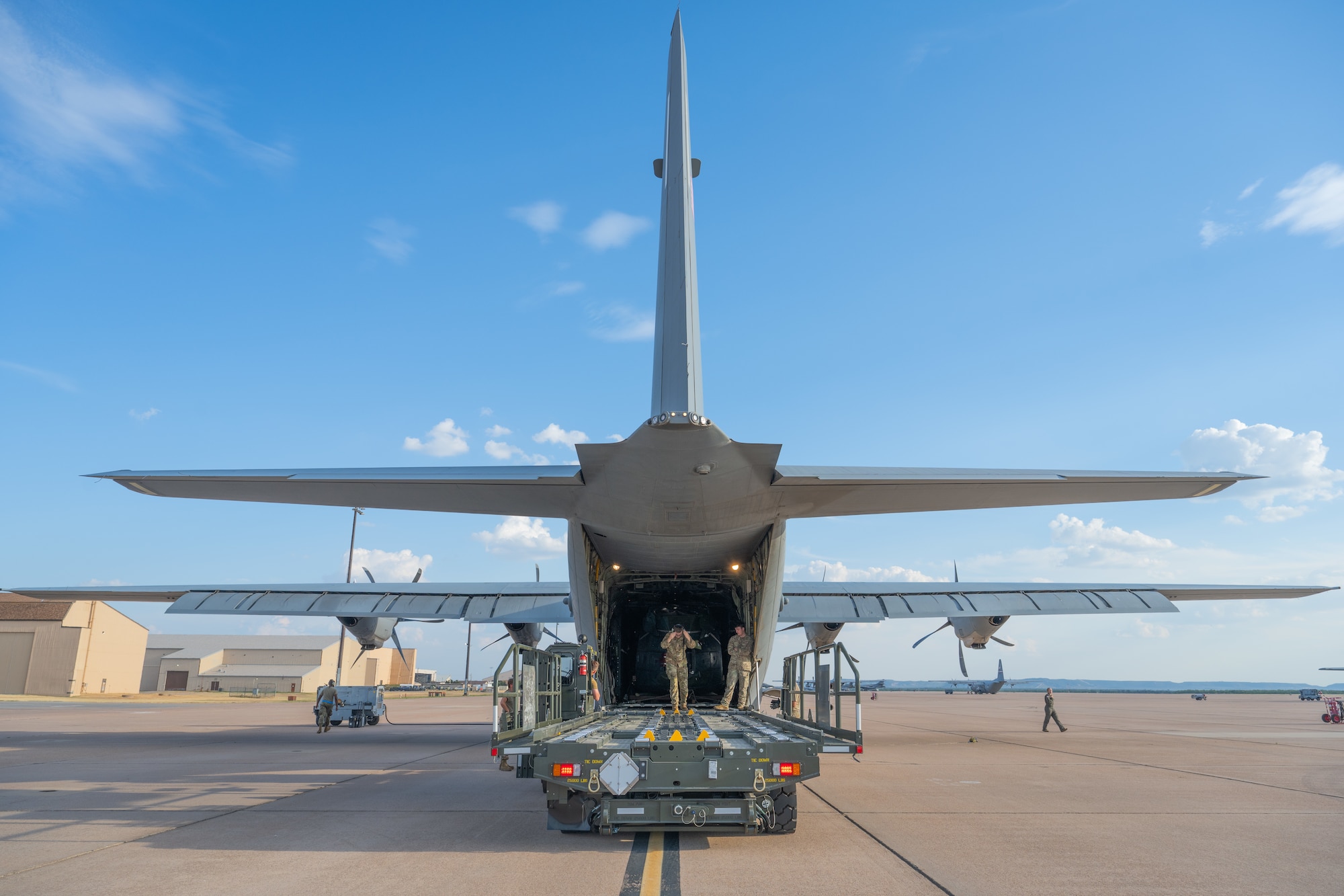 U.S. Air Force Airmen from the 7th Logistics Readiness Squadron and the 317th Airlift Wing prepare to offload a UH-1 helicopter at Dyess Air Force Base, Texas, Sept. 17, 2025. The 317th AW transported the helicopter to Dyess where it will be utilized to assist with realistic aircraft mishap response and recovery training at the 436th Training Squadron’s crash lab. (U.S. Air Force photo by Airman 1st Class Caleb Schellenberg)