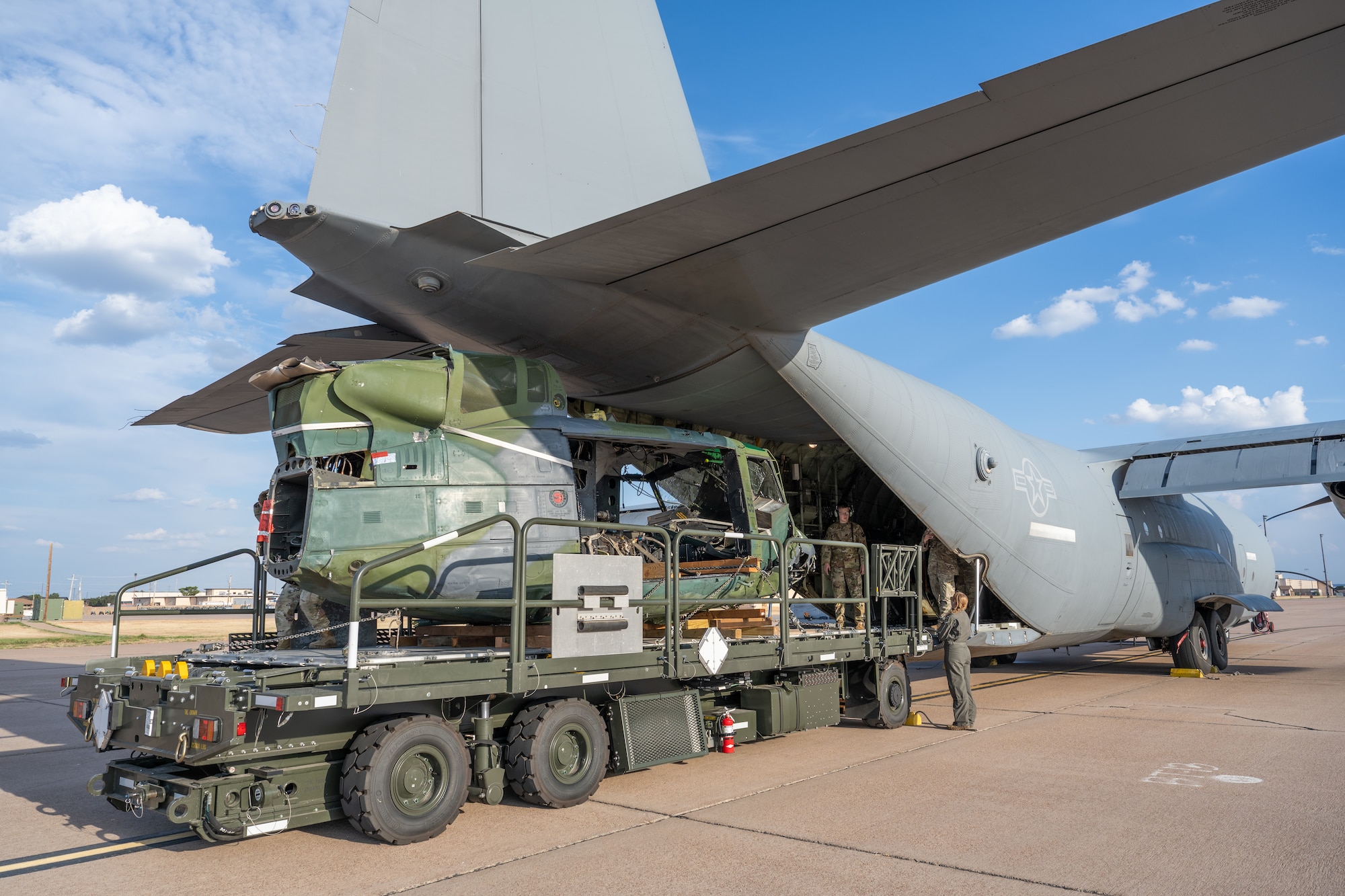 U.S. Air Force Airmen from the 7th Logistics Readiness Squadron and the 317th Airlift Wing prepare to offload a UH-1 helicopter from a C-130J Super Hercules at Dyess Air Force Base, Texas, Sept. 17, 2025. The 317th AW transported the helicopter to Dyess where it will be utilized to assist with realistic aircraft mishap response and recovery training at the 436th Training Squadron’s crash lab. (U.S. Air Force photo by Airman 1st Class Caleb Schellenberg)