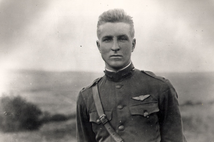 A man in a military dress uniform poses stoically for a photo.