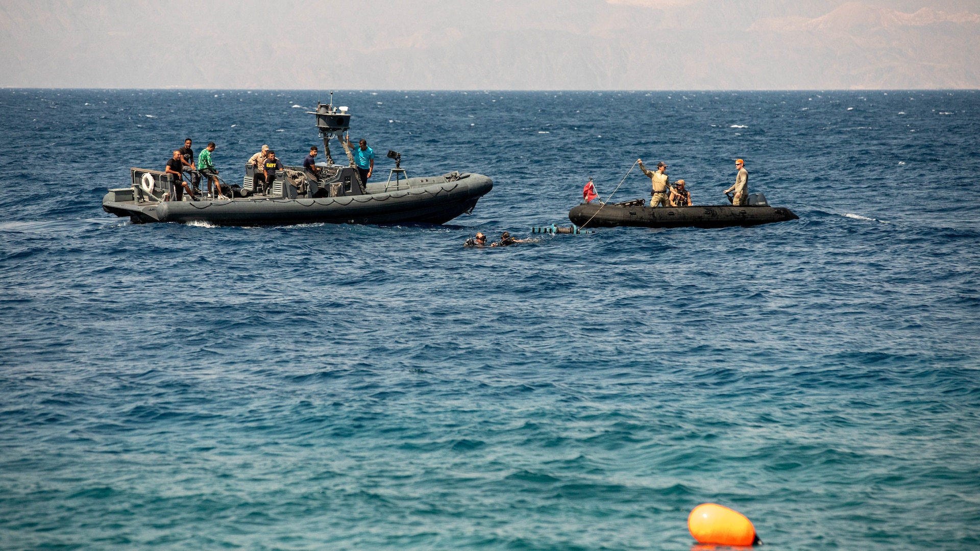 U.S. CENTRAL COMMAND AREA OF RESPONSIBILITY (Sept. 15, 2025) U.S. Navy explosive ordnance technicians assigned to U.S. Naval Forces Central Command’s Commander, Task Force (CTF) 56, right, work with members of the Jordanian Armed Forces to set explosives to neutralize a simulated sea mine in the Gulf of Aqaba, Sept. 15, 2025, during exercise INFINITE DEFENDER 25. INFINITE DEFENDER 25 is an annual, bilateral explosive ordnance disposal and maritime security exercise between U.S. 5th Fleet and the Royal Jordanian Navy to enhance mutual capabilities and interoperability. (U.S. Army photo by Sgt. Hans Williams)