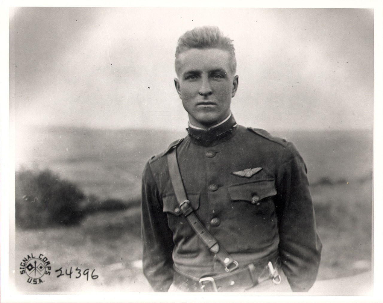 A man in a military dress uniform poses stoically for a photo.