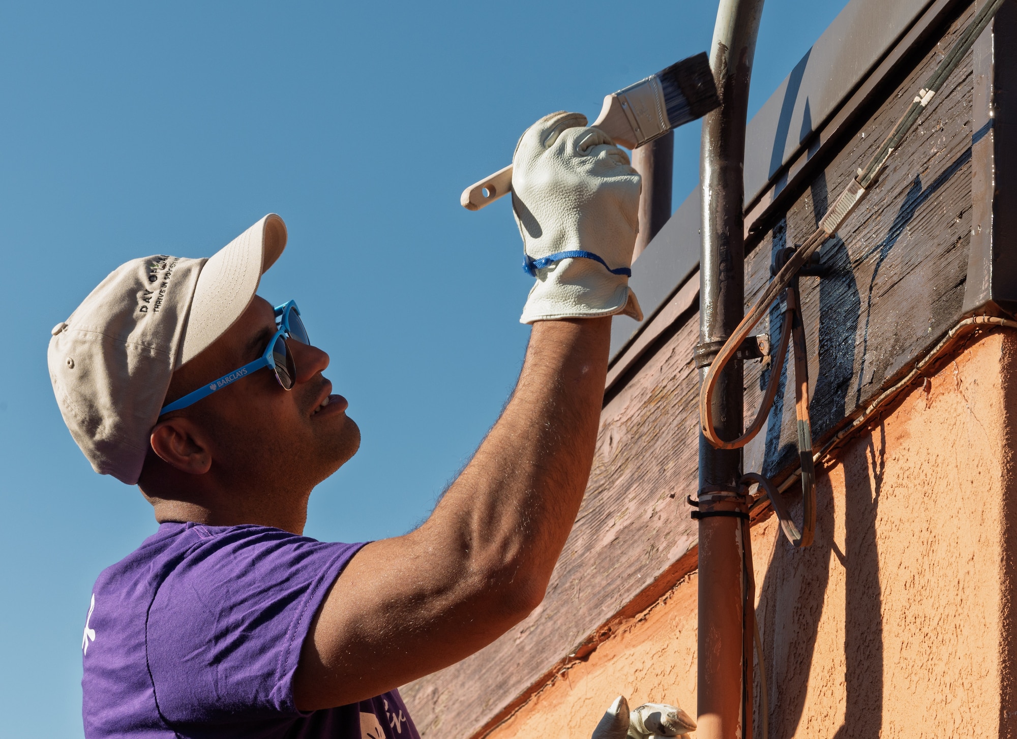 U.S. Air Force Airman 1st Class Fernando Paconio Silva, 635th Materiel Maintenance Squadron electrical systems apprentice, paints a house during the 34th annual Day of Caring event in Alamogordo, New Mexico, Sept. 12, 2025.