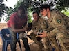U.S. Army Reserve Staff Sgt. Chanson Benjamin, right, and Sgt. 1st Class Terrence Baisley, middle, assigned to Bravo Company, Civil Affairs Battalion, U.S. Army Southern European Task Force, Africa (SETAF-AF), speak with a commander of the national assault police unit, Force de Recherche et d'Assaut de la Police (FRAP), in the northern operational zone, Côte d’Ivoire June 29, 2025. This meeting enabled the civil affairs team to gain a better understanding of the FRAP's capabilities and strengthen their relationship. (U.S. Army courtesy photo)