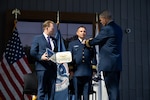 Vice Commandant Adm. Thomas Allan presents Lt. Cmdr. Ryan Major the U.S.Navy Aerial Pilot (AVP) insignia at the Robotics and Autonomous Systems (RAS) Exposition held at Coast Guard Headquarters in Washington, D.C. on August 26, 2025.