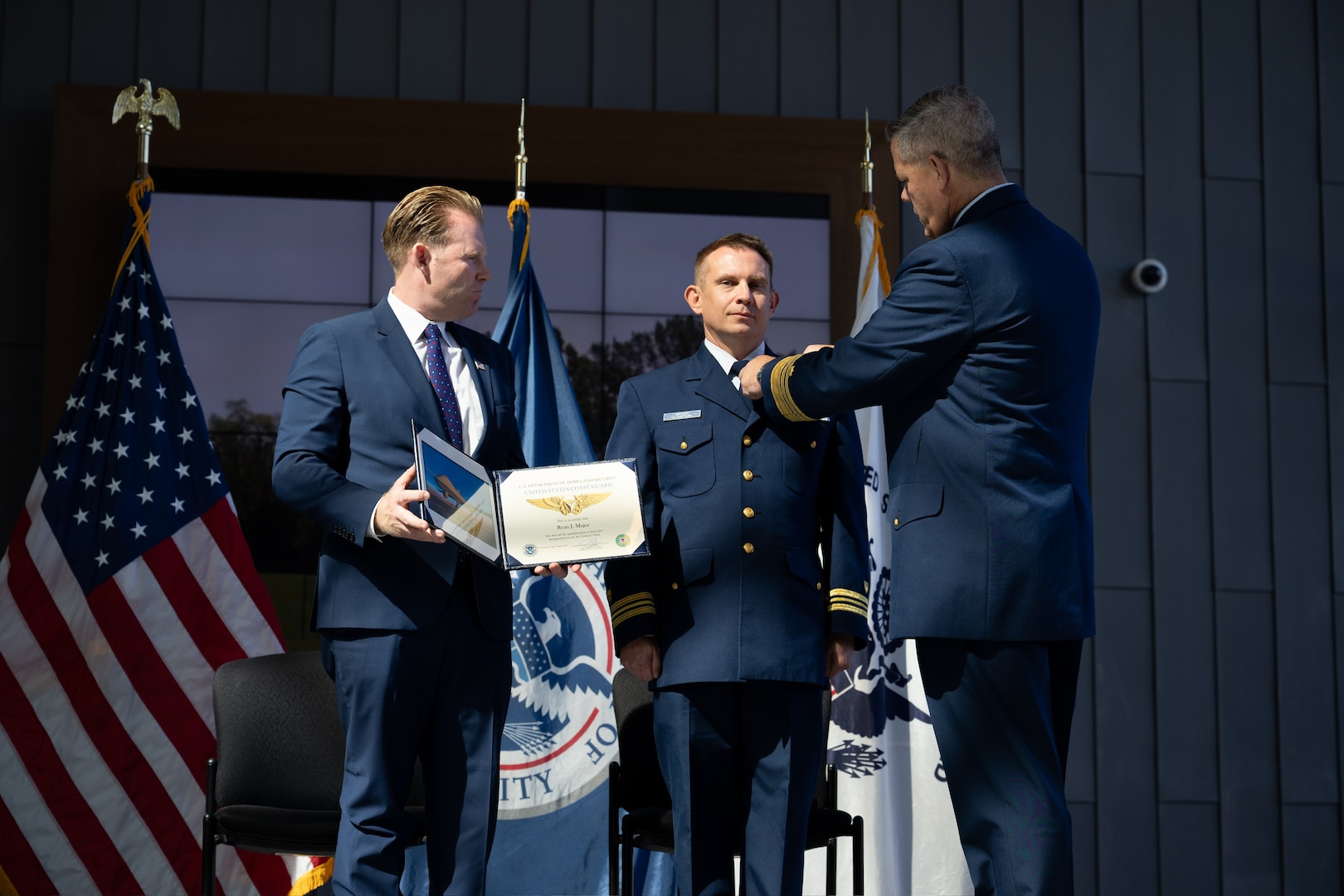 Vice Commandant Adm. Thomas Allan presents Lt. Cmdr. Ryan Major the U.S.Navy Aerial Pilot (AVP) insignia at the Robotics and Autonomous Systems (RAS) Exposition held at Coast Guard Headquarters in Washington, D.C. on August 26, 2025.