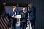 Vice Commandant Adm. Thomas Allan presents Lt. Cmdr. Ryan Major the U.S.Navy Aerial Pilot (AVP) insignia at the Robotics and Autonomous Systems (RAS) Exposition held at Coast Guard Headquarters in Washington, D.C. on August 26, 2025.