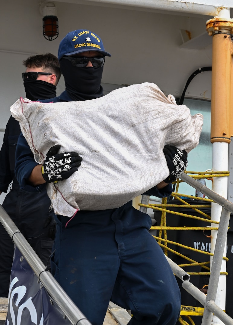 A Coast Guard Cutter Diligence (WMEC 616) crew member carries a bundle of illicit narcotics off the cutter during a drug offload at Coast Guard Sector St. Petersburg, Florida, Sept. 22, 2025. Interdictions in the Caribbean Sea are performed by members of the U.S. Coast Guard under the authority and control of the Coast Guard’s Southeast District, headquartered in Miami, Florida. (U.S. Coast Guard photo by Petty Officer 1st Class Riley Perkofski)