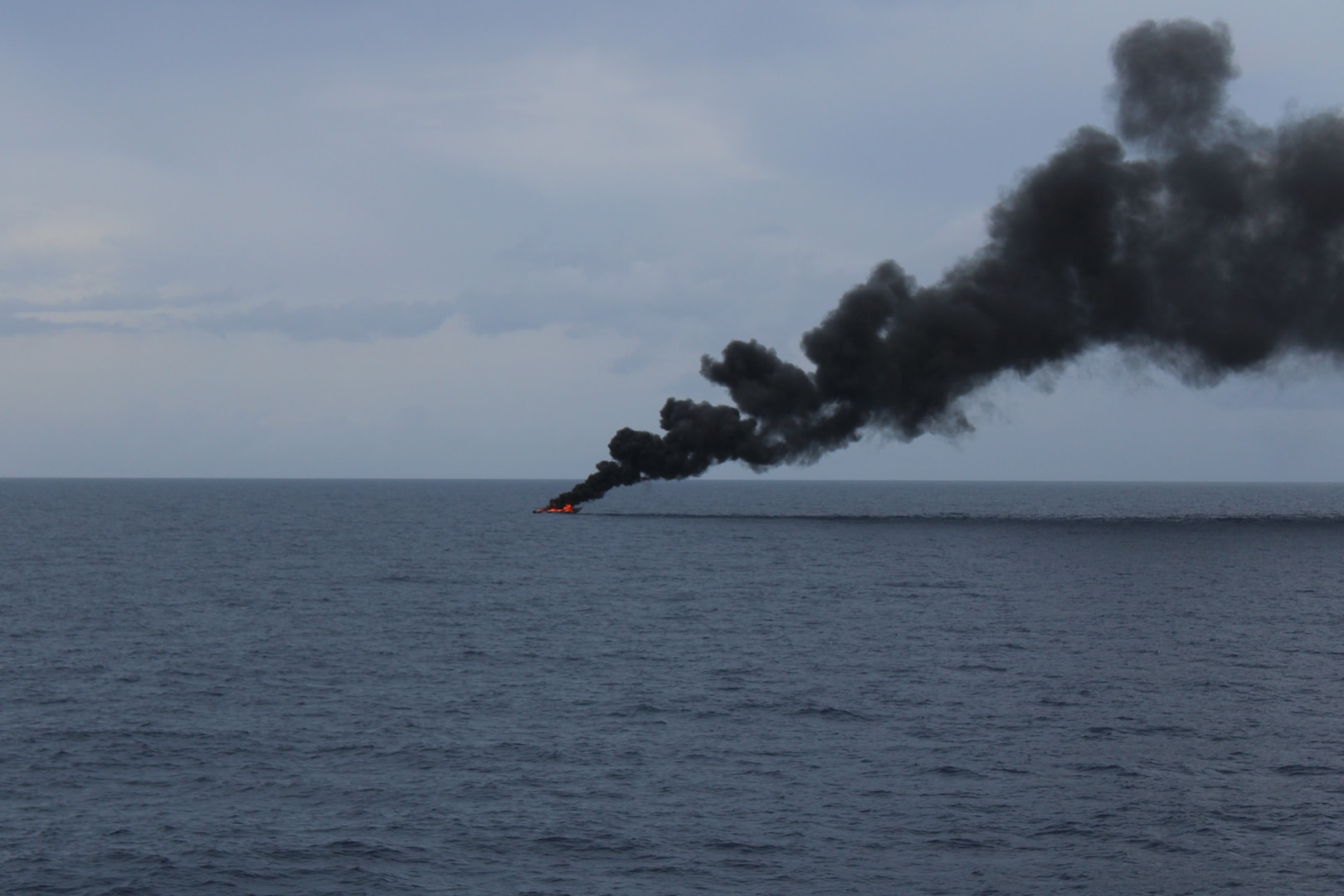 A go-fast vessel burns the day after the crew of Coast Guard Cutter Diligence (WMEC 616) interdicted the suspected drug smuggling vessel in the Caribbean Sea, Sept. 7, 2025. Diligence’s crew disrupted the go-fast style panga, suspected of trafficking more than 8,700 pounds of cocaine, worth nearly $64.5 million. (U.S. Coast Guard photo)