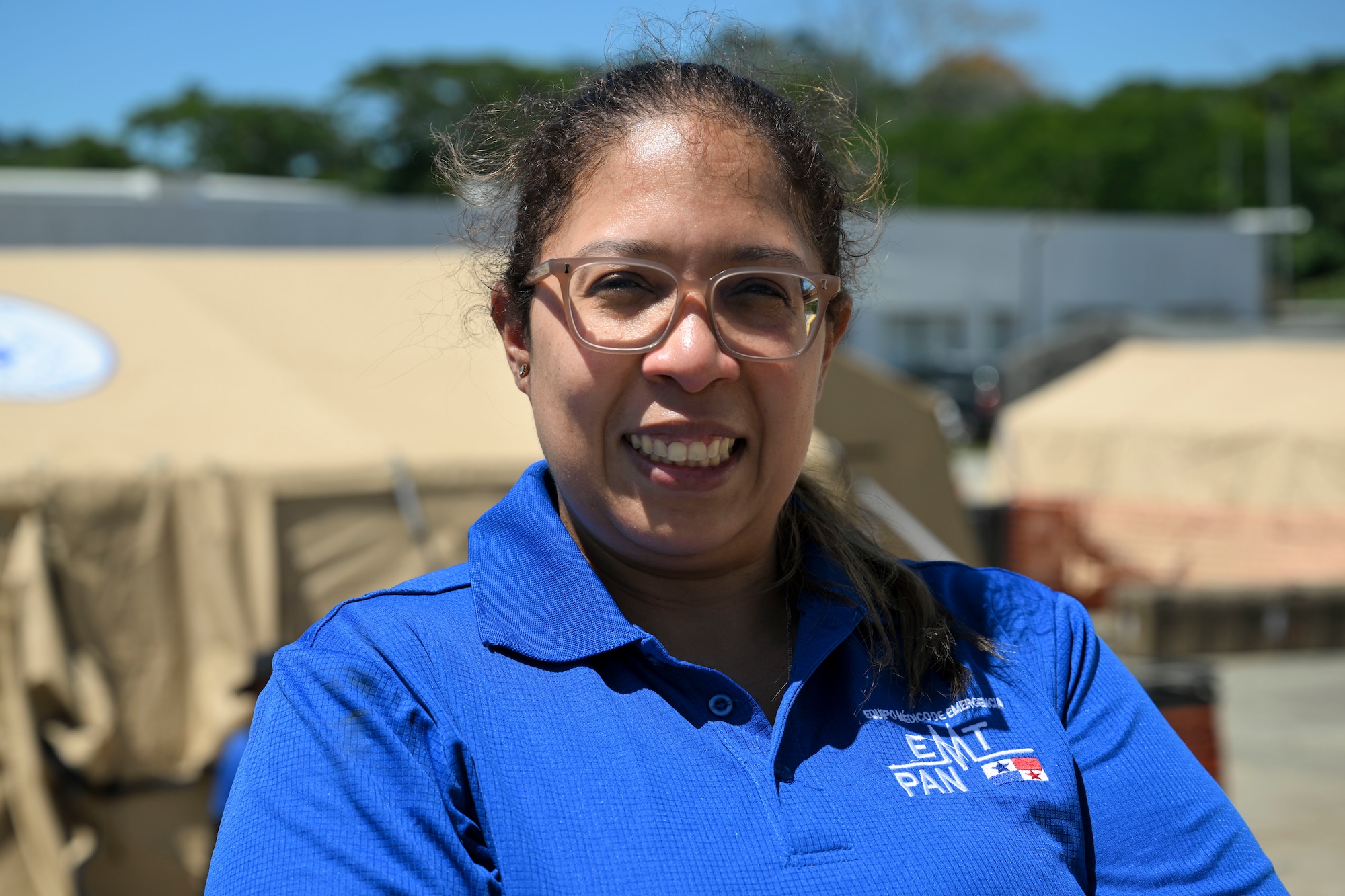 Dr. Gabriella Romero poses with the Modular Hospitals in the background ahead of the mass casualty training exercise.