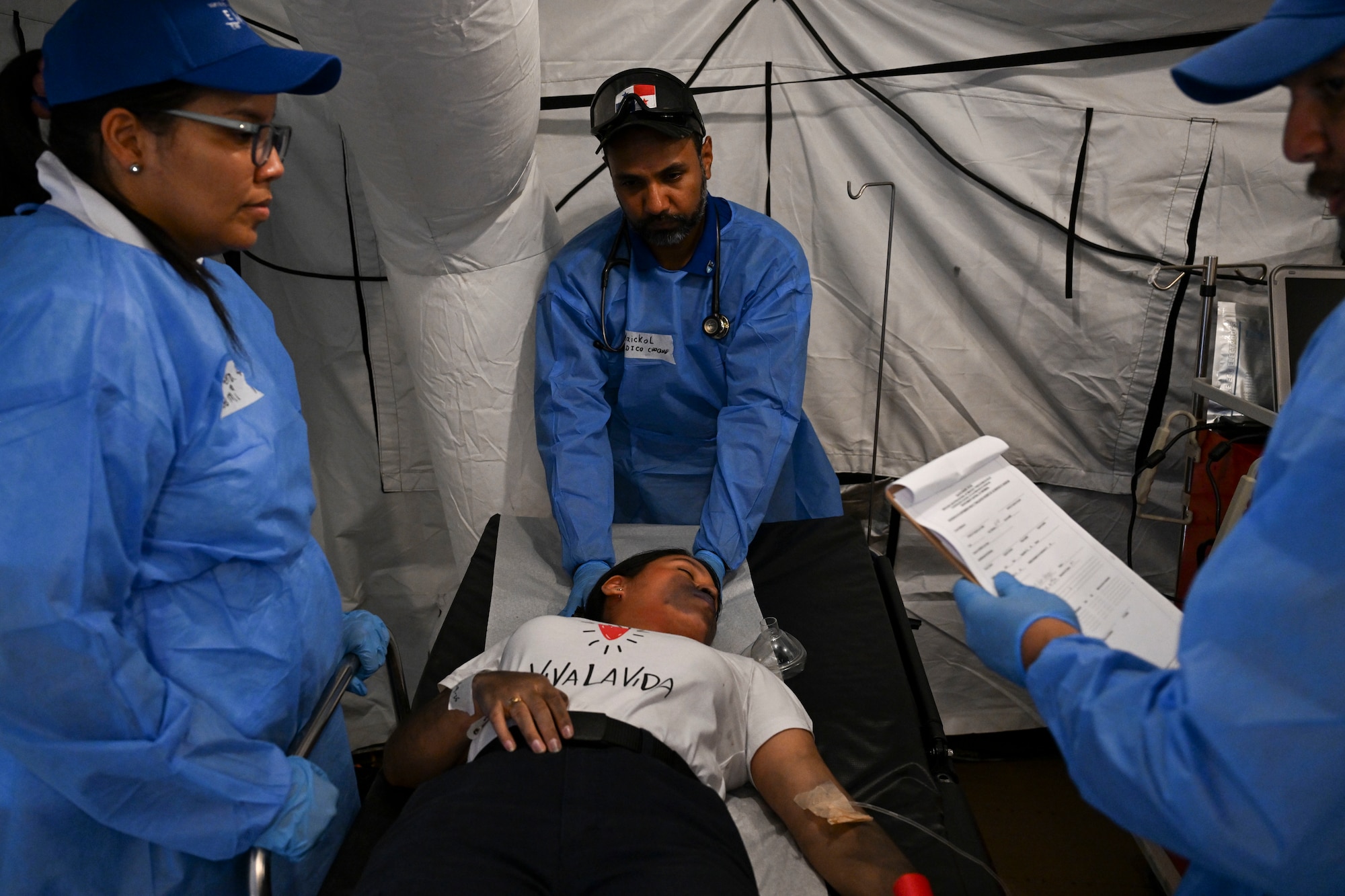 Emergency medical services conduct a MASCAL during PANAMAX rendering first aid during a pretend scenario on a fake patient.