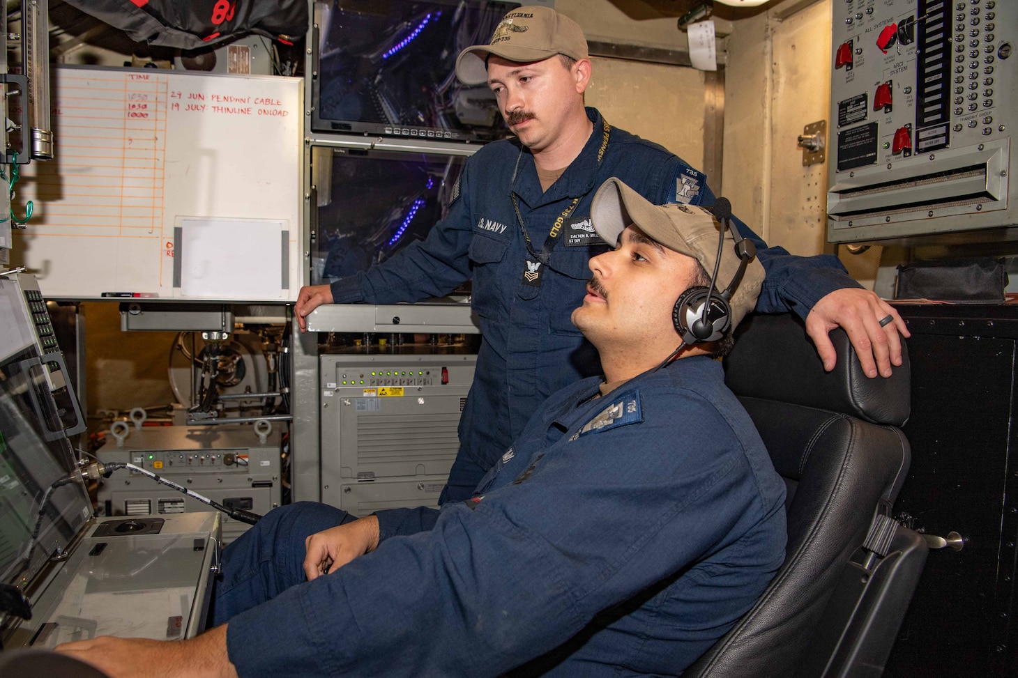 250626-N-DK460-1114 BREMERTON, Wash. (June 26, 2025) – Sonar Technician (Submarines) 2nd Class Thomas Ditizio and Sonar Technician (Submarines) 1st Class Dalton Millerdick observe a control panel aboard the Ohio-class ballistic missile submarine USS Pennsylvania (SSBN 735) June 26, 2025. Commander, Submarine Group (SUBGRU) 9 exercises administrative and operational control authority for assigned submarine commands and units in the Pacific Northwest providing oversight for shipboard training, personnel, supply and material readiness of SSBNs and their crews. SUBGRU-9 is also responsible for nuclear submarines undergoing conversion or overhaul at Puget Sound Naval Shipyard in Bremerton, Washington. SUBGRU-9’s subordinate commands include Submarine Readiness Squadron 31, Submarine Squadrons 17 and 19, eight SSBNs, two SSGNs, and four SSNs homeported in the Pacific Northwest. (U.S. Navy photo by Mass Communication Specialist 2nd Class Gwendelyn L. Ohrazda)