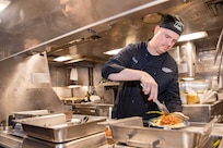 250626-N-DK460-1039 BREMERTON, Wash. (June 26, 2025) – Culinary Specialist (Submarines) 1st Class Caleb Cushing serves lunch to the crew aboard the Ohio-class ballistic missile submarine USS Pennsylvania (SSBN 735) June 26, 2025. Commander, Submarine Group (SUBGRU) 9 exercises administrative control authority for assigned submarine commands and units in the Pacific Northwest providing oversight for shipboard training, personnel, supply and material readiness of SSBNs and their crews. SUBGRU-9 is also responsible for nuclear submarines undergoing conversion or overhaul at Puget Sound Naval Shipyard in Bremerton, Washington. SUBGRU-9’s subordinate commands include Submarine Readiness Squadron 31, Submarine Squadrons 17 and 19, eight SSBNs, two SSGNs, and four SSNs homeported in the Pacific Northwest. (U.S. Navy photo by Mass Communication Specialist 2nd Class Gwendelyn L. Ohrazda)