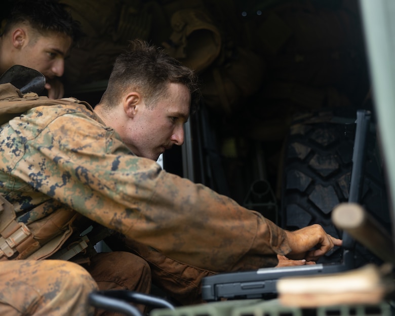 U.S. Marine Corps Lance Cpl. Bowden Miles processes a notional fire mission for the Navy-Marine Expeditionary Ship Interdiction System during an Expeditionary Advanced Base Field Training Exercise at the Central Training Area, Camp Hansen, Okinawa, Japan, July 28, 2025. The NMESIS is a ground-based offensive anti-ship missile system, used in sea denial and littoral protection to offer a highly mobile and rapidly deployable island defense solution. Miles, a native of Utah, is a field artillery cannoneer with 3d Marine Division. (U.S. Marine Corps photo by Cpl. Lucas Lu)