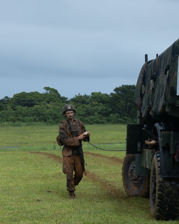 U.S. Marine Corps Lance Cpl. Bowden Miles remotely operates the Navy-Marine Expeditionary Ship Interdiction System during an Expeditionary Advanced Base Field Training Exercise at the Central Training Area, Camp Hansen, Okinawa, Japan, July 28, 2025. The NMESIS is a ground-based offensive anti-ship missile system, used in sea denial and littoral protection to offer a highly mobile and rapidly deployable island defense solution. Miles, a native of Utah, is a field artillery cannoneer with 3d Marine Division. (U.S. Marine Corps photo by Cpl. Lucas Lu)
