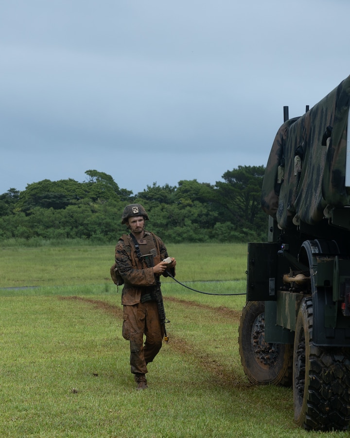 U.S. Marine Corps Lance Cpl. Bowden Miles remotely operates the Navy-Marine Expeditionary Ship Interdiction System during an Expeditionary Advanced Base Field Training Exercise at the Central Training Area, Camp Hansen, Okinawa, Japan, July 28, 2025. The NMESIS is a ground-based offensive anti-ship missile system, used in sea denial and littoral protection to offer a highly mobile and rapidly deployable island defense solution. Miles, a native of Utah, is a field artillery cannoneer with 3d Marine Division. (U.S. Marine Corps photo by Cpl. Lucas Lu)