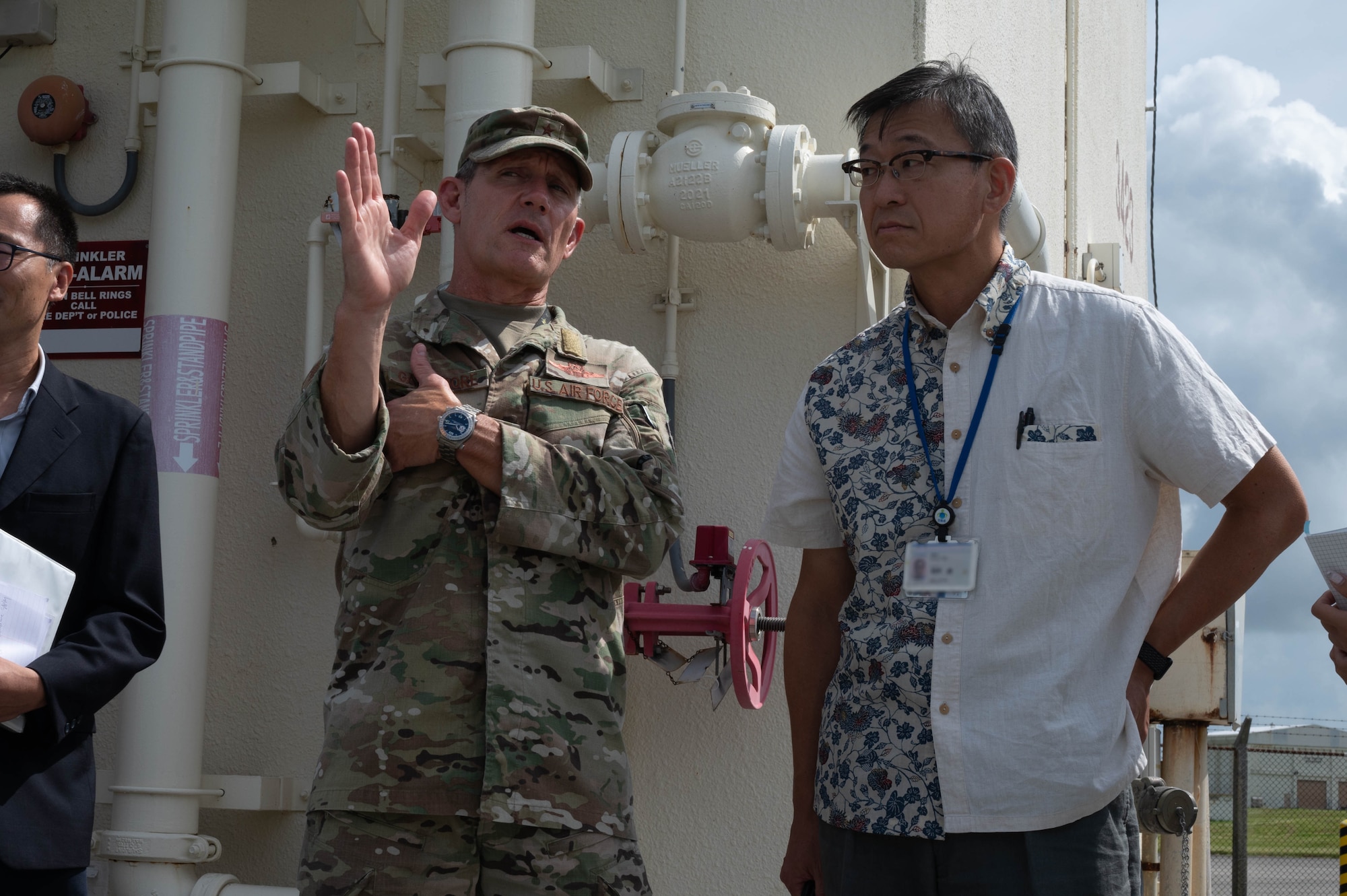 U.S. Air Force Brig. Gen. John Gallemore, 18th Wing commander, briefs Mr. Masaru Murai, Okinawa Defense Bureau director general, during a familiarization tour at Kadena Air Base, Sept. 11, 2025.