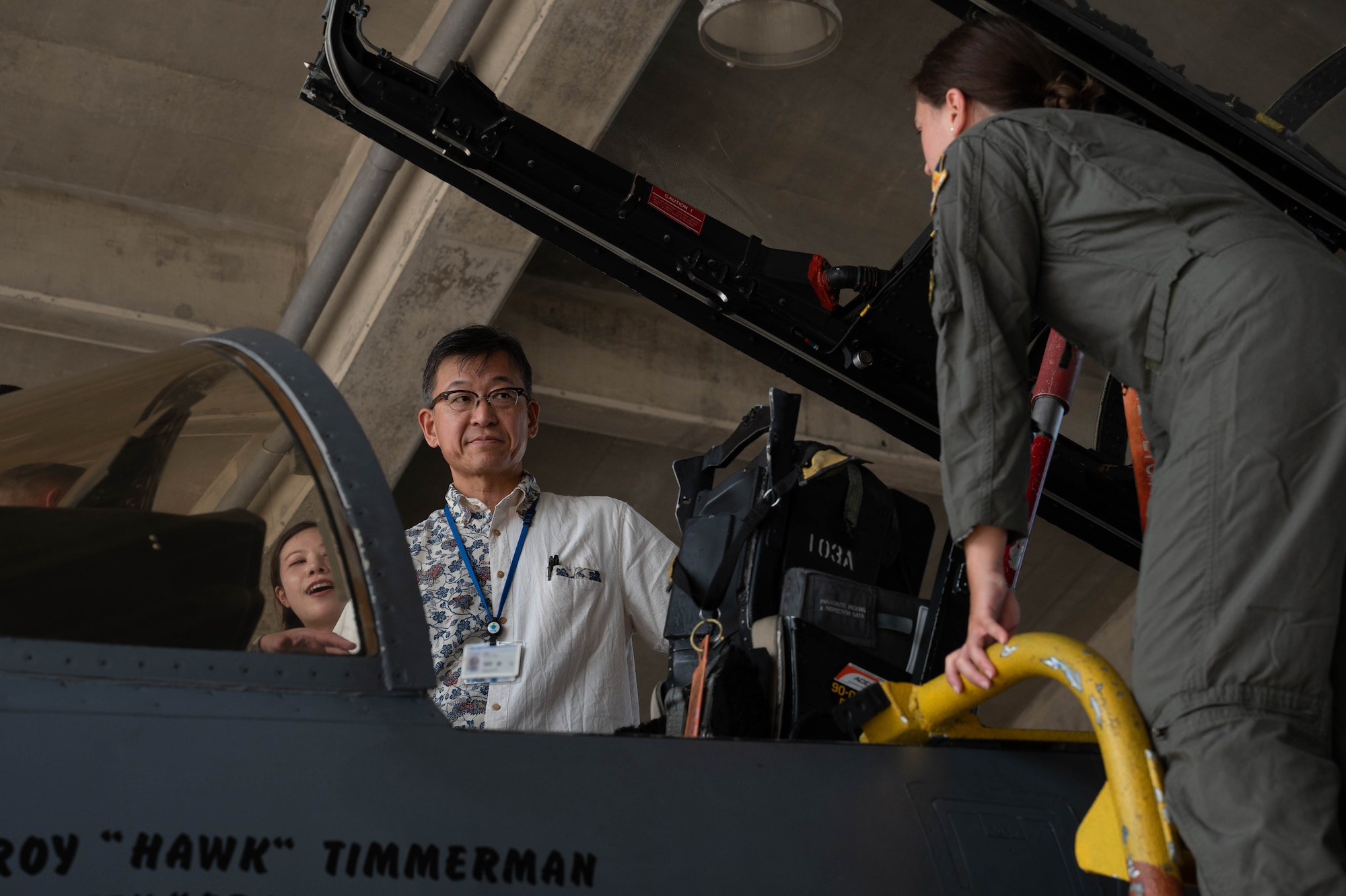 U.S. Air Force Capt. Taylor Pond, 336th Expeditionary Fighter Squadron pilot, briefs Mr. Masaru Murai, Okinawa Defense Bureau director general, on F-15E Strike Eagle capabilities during a familiarization tour at Kadena Air Base, Sept. 11, 2025.