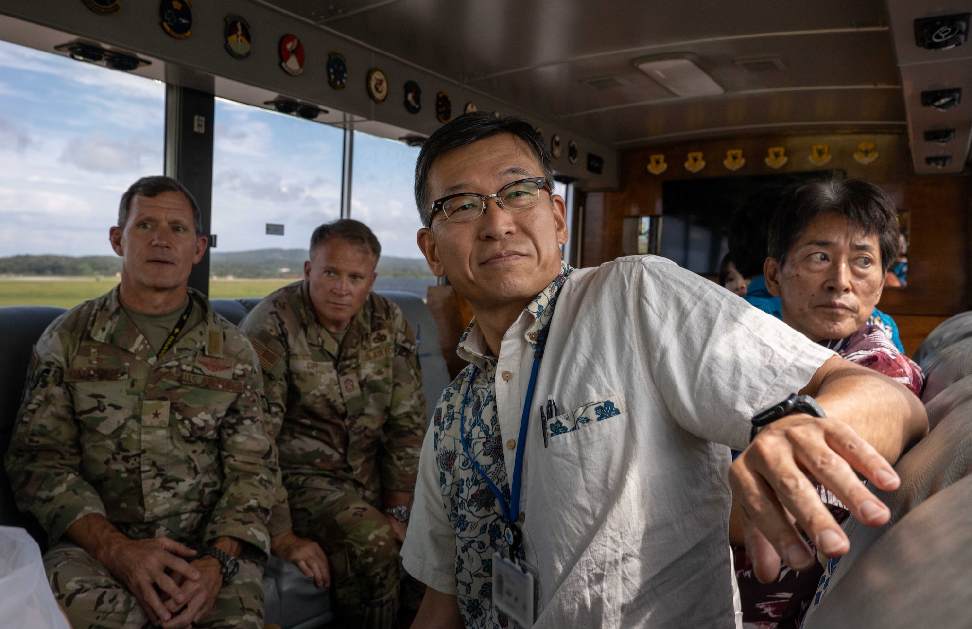 U.S. Air Force Brig. Gen. John Gallemore, 18th Wing commander, Chief Master Sgt. William Cupp, 18th Wing command chief, and Mr. Masaru Murai, Okinawa Defense Bureau director general, view the Kadena Air Base flightline during a familiarization tour, Sept. 11, 2025.