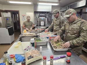 U.S. Airmen with the 156th Force Support Squadron, Puerto Rico Air National Guard, prepare meals during an Innovative Readiness Training project at Redwoods National Park, California, June 2025. IRT delivers joint training opportunities to increase deployment readiness and provides key services to American communities. (U.S. Air National Guard courtesy photo)