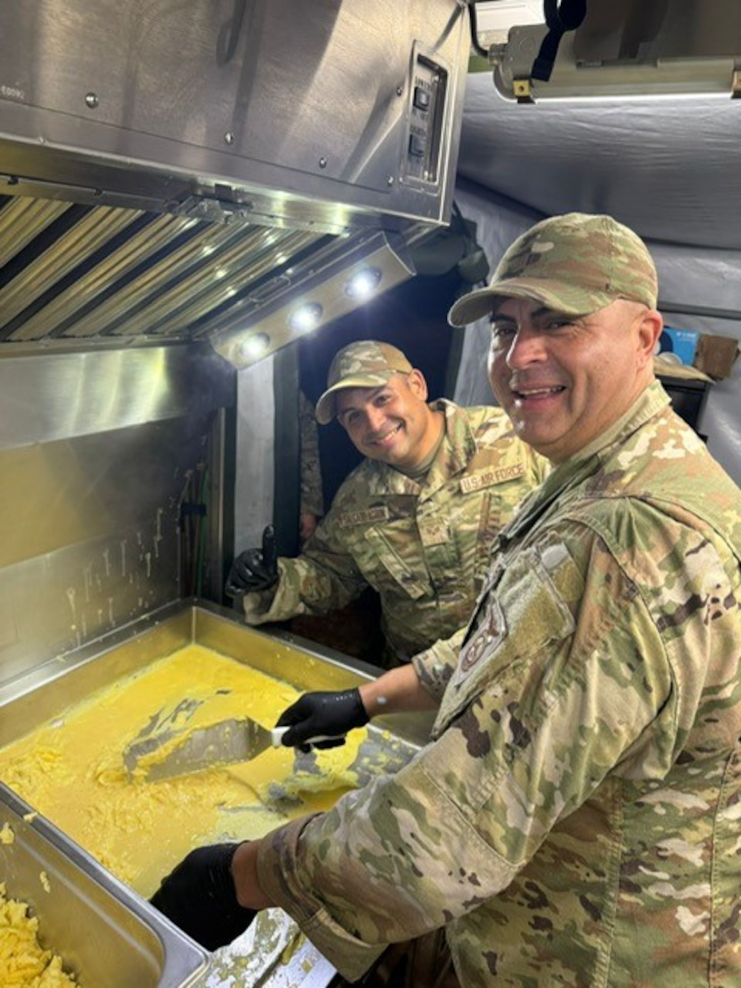 U.S. Airmen with the 156th Force Support Squadron, Puerto Rico Air National Guard, prepare meals during an Innovative Readiness Training project at Kapolei, Hawaii, August 2025. IRT delivers joint training opportunities to increase deployment readiness and provides key services to American communities. (U.S. Air National Guard courtesy photo)