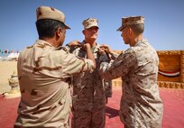 Egyptian Brig. Gen. Amro Hassan, left, the commanding general of 3rd Mechanized Infantry Division, and U.S. Marine Corps Brig. Gen. Stephen Lightfoot, right, the commanding general of Task Force 51/5th Marine Expeditionary Brigade, pin rank insignia on Col. Brian Blaine, the director of operations for Task Force 51/5th Marine Expeditionary Brigade, as part of his promotion ceremony during BRIGHT STAR 25 at Mohamed Naguib Military Base (MNMB), Egypt, Sept. 1, 2025.