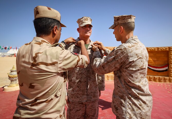 Egyptian Brig. Gen. Amro Hassan, left, the commanding general of 3rd Mechanized Infantry Division, and U.S. Marine Corps Brig. Gen. Stephen Lightfoot, right, the commanding general of Task Force 51/5th Marine Expeditionary Brigade, pin rank insignia on Col. Brian Blaine, the director of operations for Task Force 51/5th Marine Expeditionary Brigade, as part of his promotion ceremony during BRIGHT STAR 25 at Mohamed Naguib Military Base (MNMB), Egypt, Sept. 1, 2025.