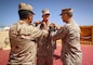 Egyptian Brig. Gen. Amro Hassan, left, the commanding general of 3rd Mechanized Infantry Division, and U.S. Marine Corps Brig. Gen. Stephen Lightfoot, right, the commanding general of Task Force 51/5th Marine Expeditionary Brigade, pin rank insignia on Col. Brian Blaine, the director of operations for Task Force 51/5th Marine Expeditionary Brigade, as part of his promotion ceremony during BRIGHT STAR 25 at Mohamed Naguib Military Base (MNMB), Egypt, Sept. 1, 2025.