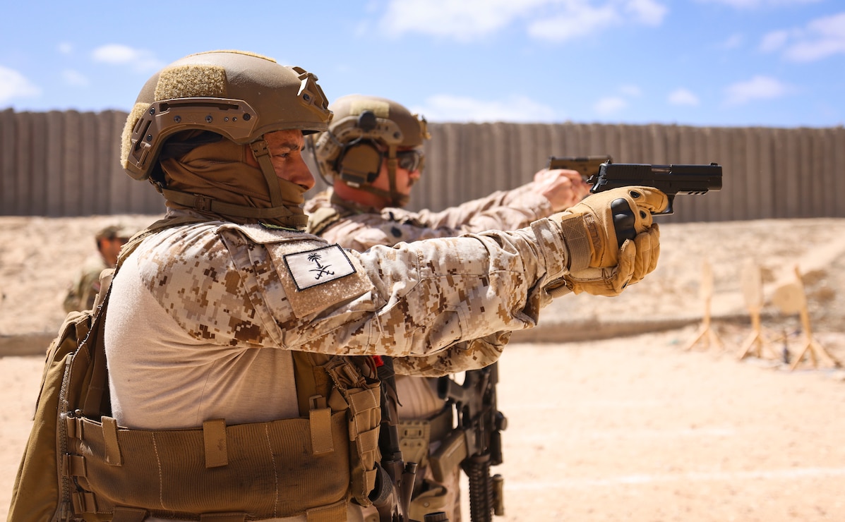 A Saudi Arabian special forces service member, left, and U.S. Marine Corps Staff Sgt. Peyton Capone, a platoon sergeant with Alpha Company, Fleet Anti-terrorism Security Team Central Command, fire P226 and M18 pistols during BRIGHT STAR 25 at Ras Al Tin Naval Base, Egypt, Sept. 2, 2025.