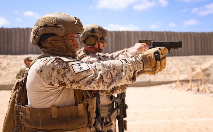 A Saudi Arabian special forces service member, left, and U.S. Marine Corps Staff Sgt. Peyton Capone, a platoon sergeant with Alpha Company, Fleet Anti-terrorism Security Team Central Command, fire P226 and M18 pistols during BRIGHT STAR 25 at Ras Al Tin Naval Base, Egypt, Sept. 2, 2025.