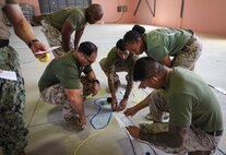 U.S. Marines and Sailors with Task Force 51/5th Marine Expeditionary Brigade build a terrain model for the command post exercise during BRIGHT STAR 25 at Mohamed Naguib Military Base (MNMB), Egypt, Aug. 30, 2025.