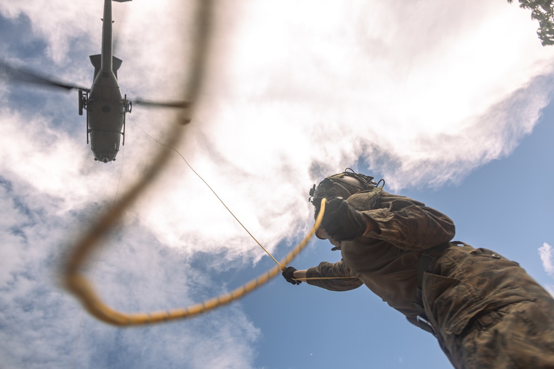 U.S. Marine Corps Lance Cpl. Maxton Graham, a rifleman with Animal Company, Battalion Landing Team 1st Battalion, 7th Marine Regiment, 31st Marine Expeditionary Unit, secures a simulated casualty hoisted by a UH-1Y Venom assigned to Marine Medium Tiltrotor Squadron (VMM) 265 (Rein.), 31st MEU, during hoist training at the Jungle Warfare Training Center, Okinawa, Japan, Sept. 16, 2025. Marines participated in training to enhance their proficiency and comfortability while conducting casualty evacuation in harsh jungle environments. The 31st MEU, the Marine Corps’ only continuously forward-deployed MEU, provides a flexible and lethal force ready to perform a wide range of military operations as the premiere crisis response force in the Indo-Pacific region. (U.S. Marine Corps photo by Lance Cpl. Victor Gurrola)