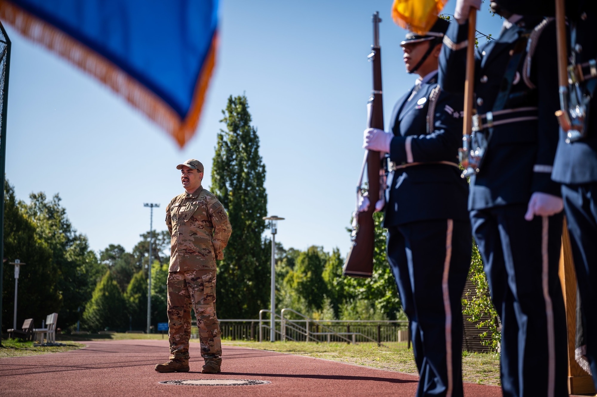 An Airman sings the National Anthem during a POW/MIA remembrance ceremony