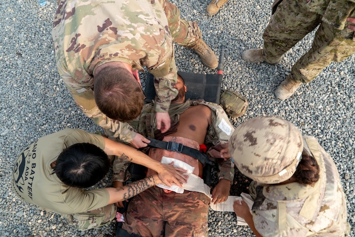 An overhead shot of medics circling a casualty mid-frame