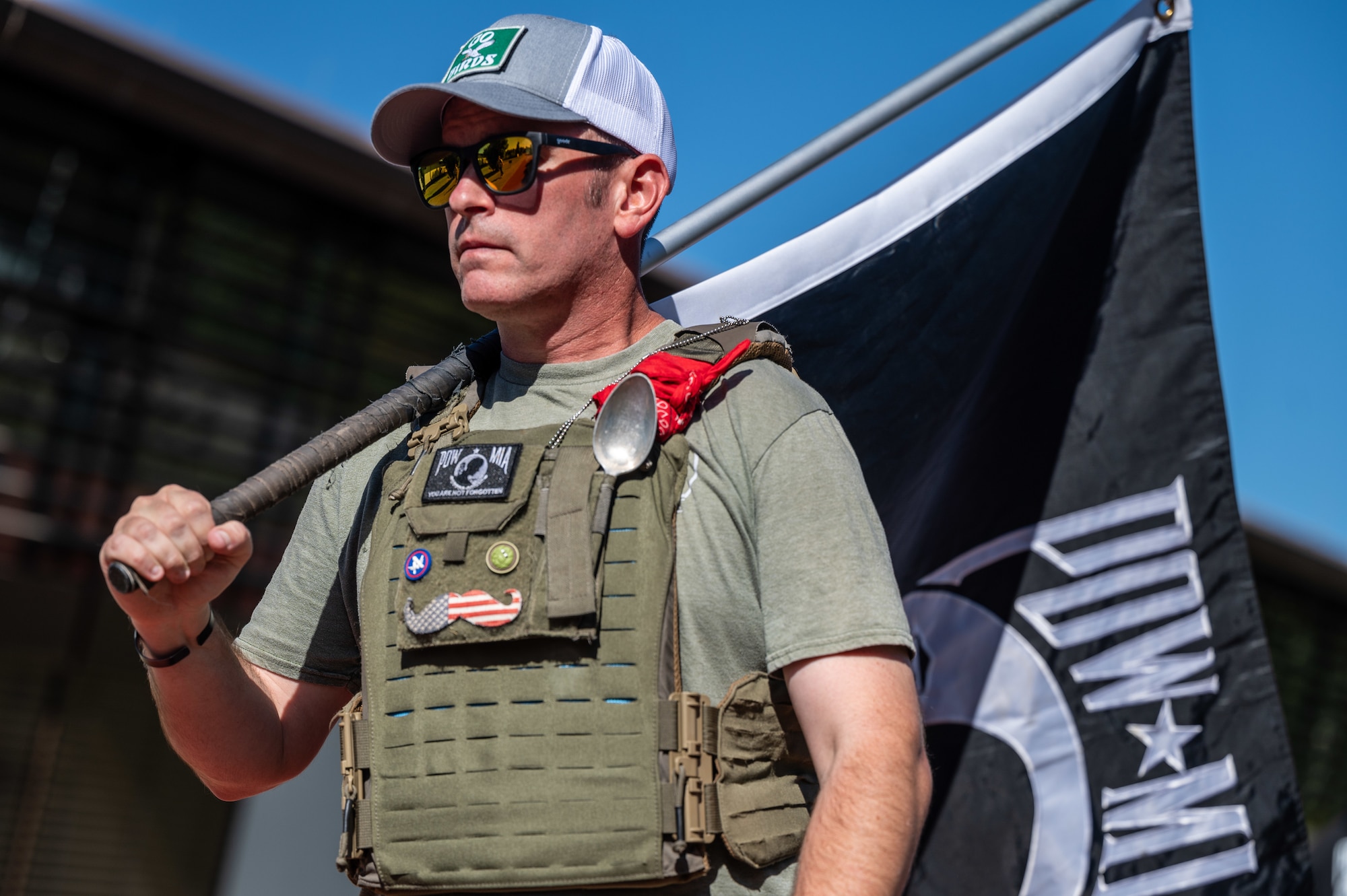 U.S. Air Force Master Sgt. Trevor Derr, 721st Aircraft Maintenance Squadron assistant aircraft maintenance unit superintendent, carries a POW/MIA flag during a POW/MIA remembrance walk