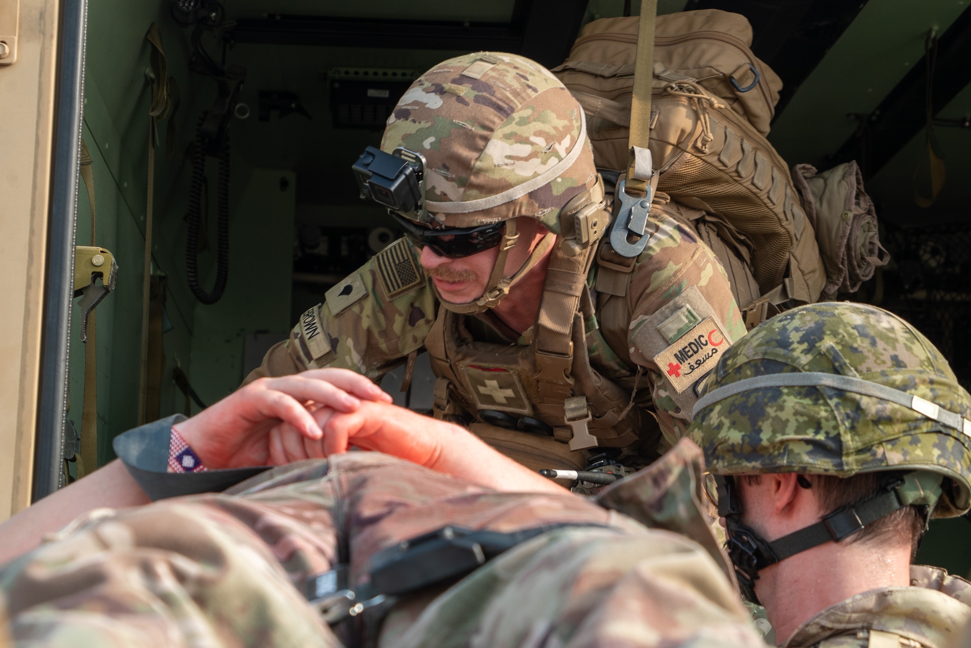 Spc. Brown pulls in a casualty from right of frame