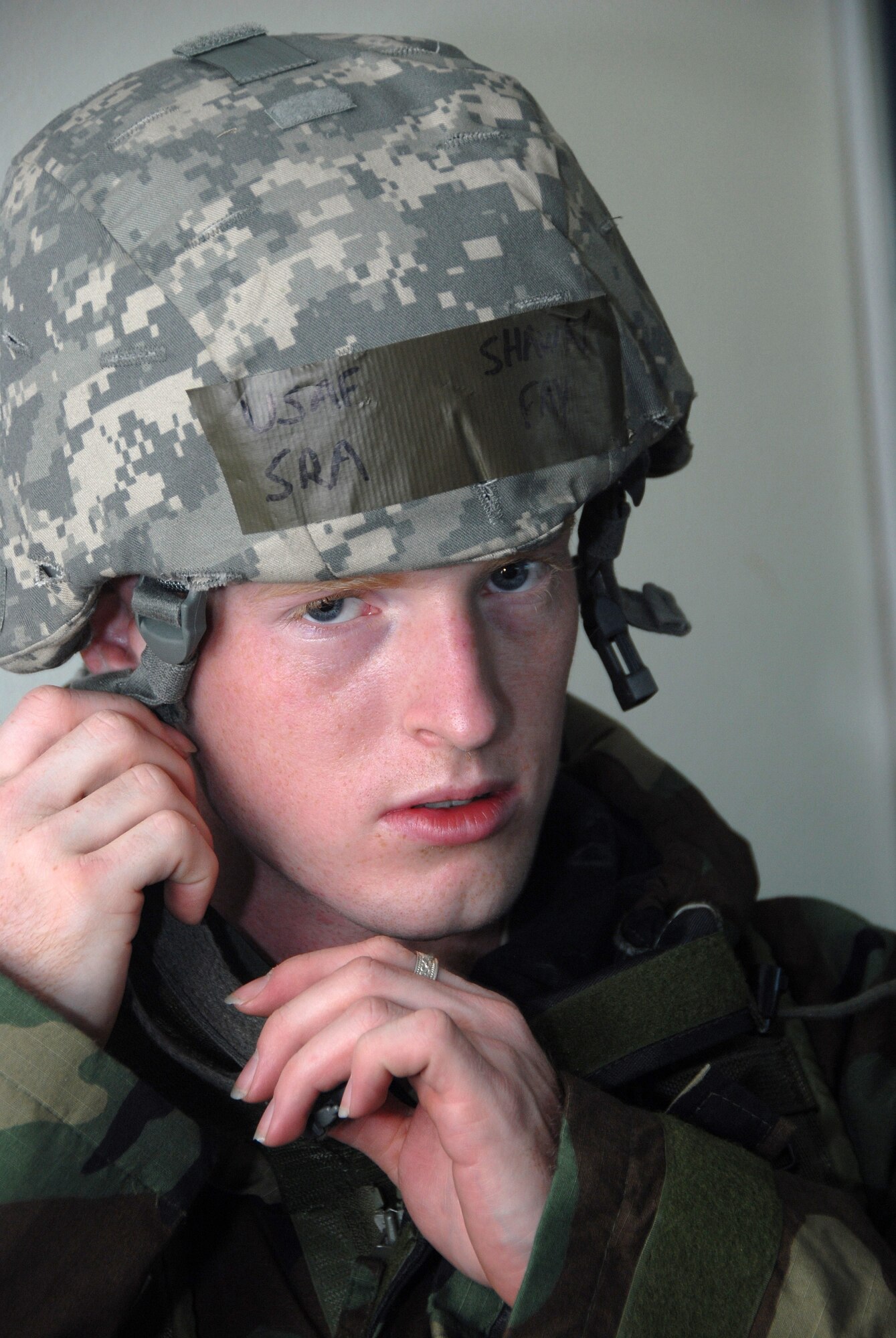 Senior Airman Shawn Fay of the Kentucky Air National Guard’s 123rd Airlift Wing straps on his Kevlar helmet in preparation for a mock attack by aggressors during an Operational Readiness Exercise at Volk Field, Wis., June 23, 2009. The event tested the wing’s ability to support homeland defense operations. (U.S. Air National Guard photos by Tech. Sgt. Dennis Flora)