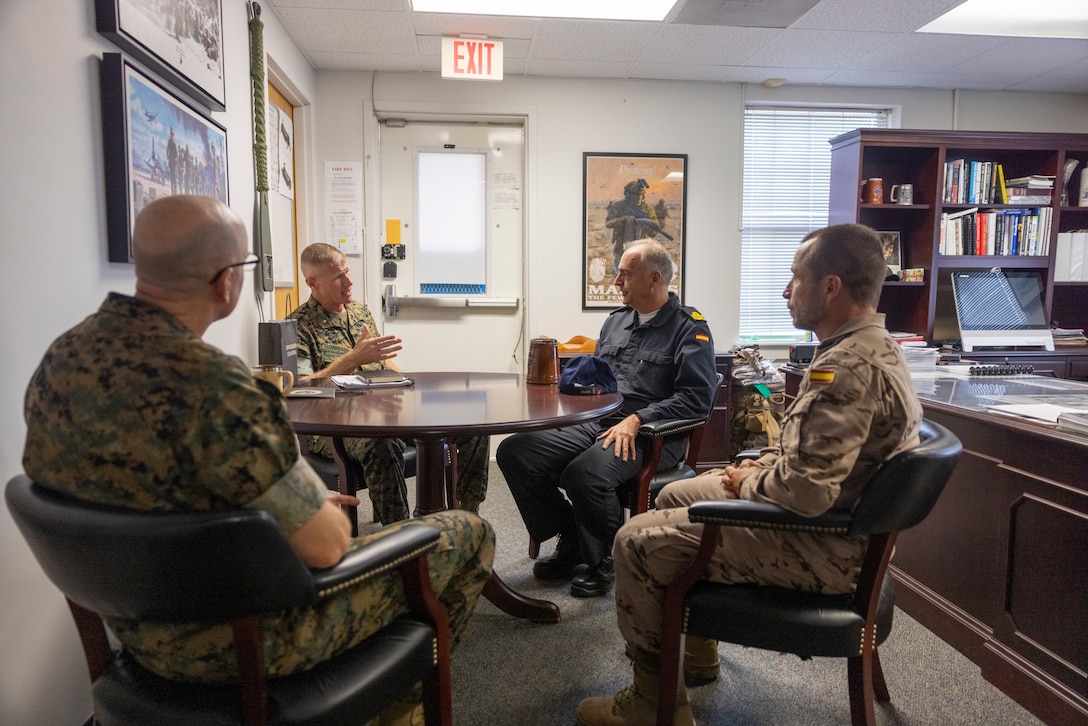 U.S. Marine Corps Brig. Gen. Kevin Jarrard, center-left, the UNITAS 2025 combined task group commander and commanding general of 4th Marine Division U.S. Marine Corps Col. Ben Reid, left, the commanding officer of the 26th Marine Expeditionary Unit, and Spanish Armada El contraalmirante, Antonio González-Tanago de la Lastra, center-right, speak with each other during a visit to the 26th Marine Expeditionary Unit headquarters during exercise UNITAS 2025 at Marine Corps Base Camp Lejeune at North Carolina, Sept. 22, 2025. UNITAS, which is Latin for “unity,” was conceived in 1959 and has taken place annually since first conducted in 1960. This year marks the 66th iteration of the world’s longest running annual multinational maritime exercise. (U.S. Marine Corps photo by Lance Cpl. Payton Goodrich)
