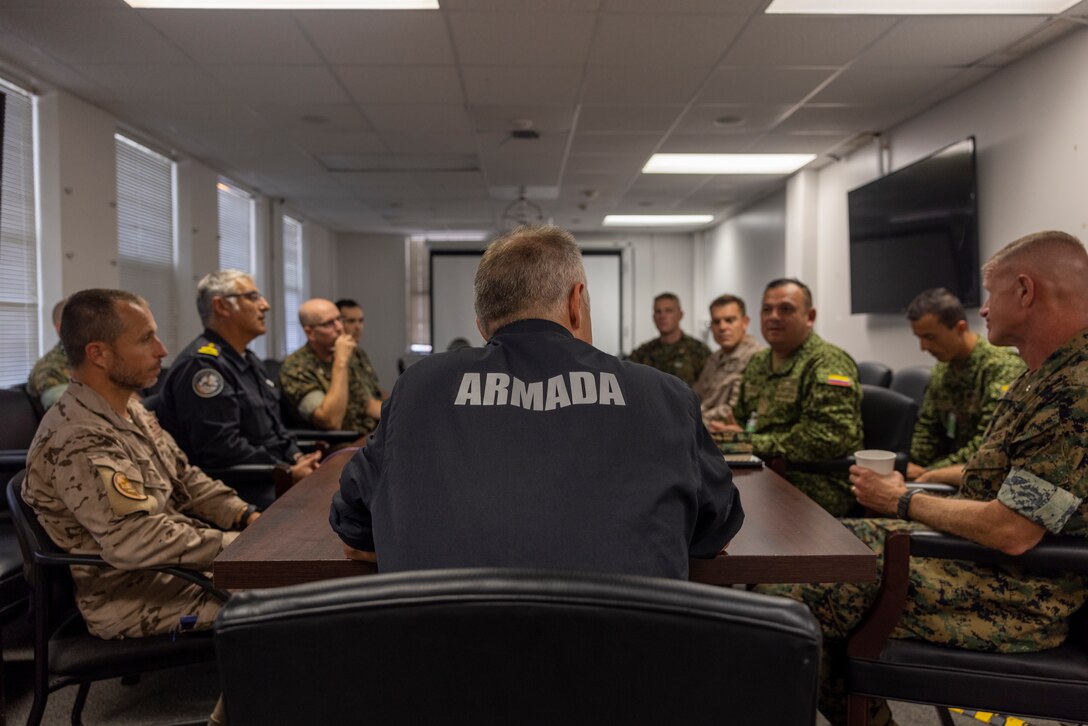 Spanish Armada El contraalmirante, Antonio González-Tanago de la Lastra, center, meets with U.S. Marines, and marines from Colombia and Spain, during a visit to the 26th Marine Expeditionary Unit headquarters during exercise UNITAS 2025 at Marine Corps Base Camp Lejeune at North Carolina, Sept. 22, 2025. UNITAS, which is Latin for “unity,” was conceived in 1959 and has taken place annually since first conducted in 1960. This year marks the 66th iteration of the world’s longest running annual multinational maritime exercise. (U.S. Marine Corps photo by Lance Cpl. Payton Goodrich)