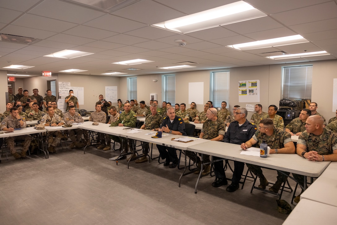 U.S. Marine Corps Brig. Gen. Kevin Jarrard, center-left, the UNITAS 2025 combined task group commander and commanding general of 4th Marine Division  Spanish Armada El contraalmirante, Antonio González-Tanago de la Lastra, center, and U.S. Marine Corps Col. Ben Reid, the commanding officer of the 26th Marine Expeditionary Unit, center-right, discuss plans to conduct a combined amphibious assault during exercise UNITAS 2025 at Marine Corps Base Camp Lejeune at North Carolina, Sept. 22, 2025. UNITAS, which is Latin for “unity,” was conceived in 1959 and has taken place annually since first conducted in 1960. This year marks the 66th iteration of the world’s longest running annual multinational maritime exercise. (U.S. Marine Corps photo by Lance Cpl. Payton Goodrich)