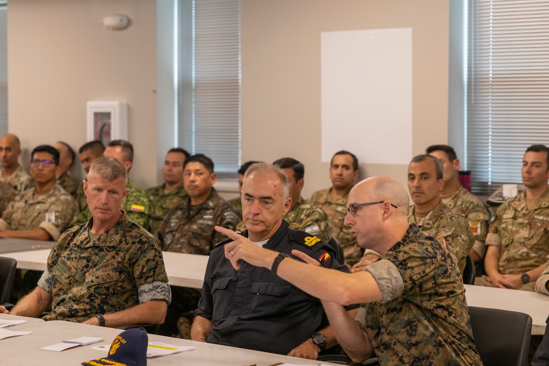 U.S. Marine Corps Col. Ben Reid, right, the commanding officer of the 26th Marine Expeditionary Unit, discusses key decisions with Spanish Armada El contraalmirante, Antonio González-Tanago de la Lastra, center, during a combined amphibious assault planning brief as part of exercise UNITAS 2025 at Marine Corps Base Camp Lejeune at North Carolina, Sept. 22, 2025. UNITAS, which is Latin for “unity,” was conceived in 1959 and has taken place annually since first conducted in 1960. This year marks the 66th iteration of the world’s longest running annual multinational maritime exercise. (U.S. Marine Corps photo by Lance Cpl. Payton Goodrich)