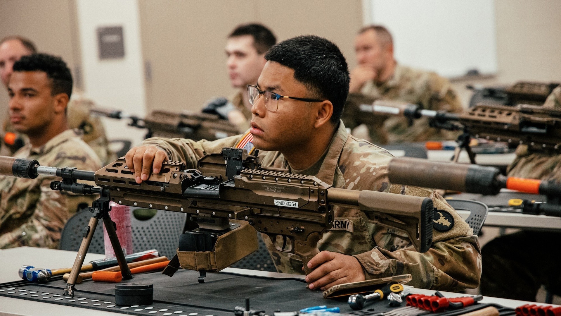 Soldiers with the 34th Infantry Division receive instruction on the M250 automatic rifle during a New Equipment Training fielding at Camp Ripley, Minn., September 15, 2025.