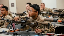Soldiers with the 34th Infantry Division receive instruction on the M250 automatic rifle during a New Equipment Training fielding at Camp Ripley, Minn., September 15, 2025.