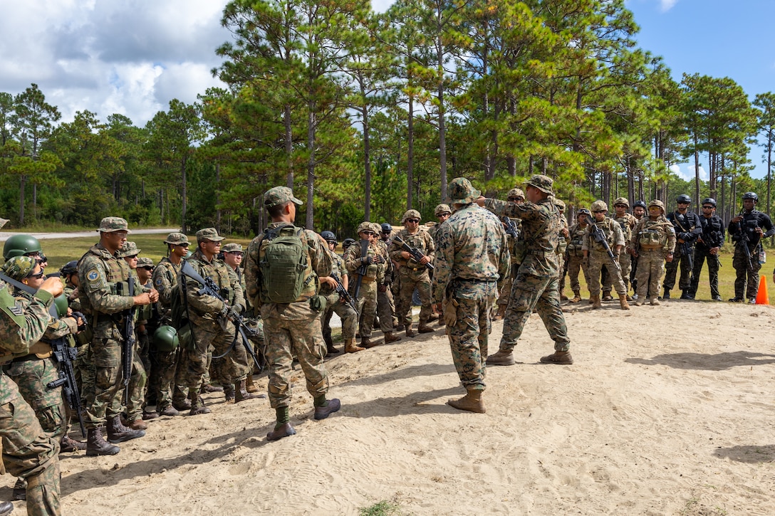 U.S. Marines with Golf Company, 2nd Battalion, 2nd Marine Regiment, give a safety brief to marines from participating multinational forces during a multinational marksmanship range as part of exercise UNITAS 2025 at Marine Corps Base Camp Lejeune, North Carolina, Sept. 23, 2025. UNITAS, which is Latin for “unity,” was conceived in 1959 and has taken place annually since first conducted in 1960. This marks the 66th iteration of the world’s longest running annual multinational maritime exercise. (U.S. Marine Corps photo by Lance Cpl. Jack Labrador)