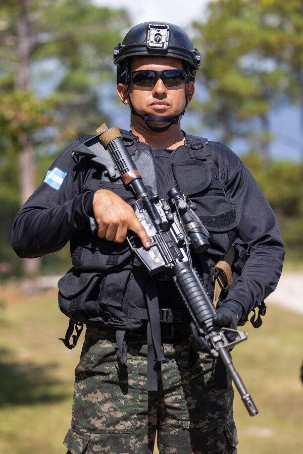 Teniente de Fragata Cordon Peralta, a marine with Infanteria de Marina Fuerza Naval de Honduras (Honduran marine infantry) stands in line during a multinational marksmanship range as part of exercise UNITAS 2025 at Marine Corps Base Camp Lejeune, North Carolina, Sept. 23, 2025. UNITAS, which is Latin for “unity,” was conceived in 1959 and has taken place annually since first conducted in 1960. This marks the 66th iteration of the world’s longest running annual multinational maritime exercise. (U.S. Marine Corps photo by Lance Cpl. Jack Labrador)
