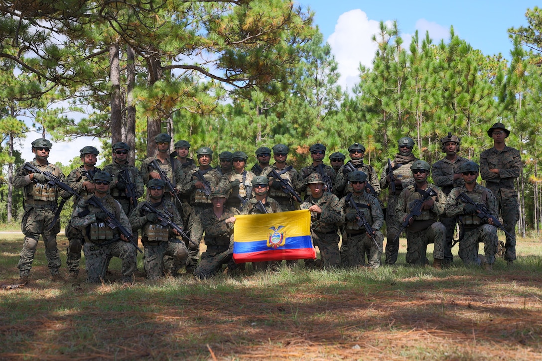 Marines with Cuerpo de Infanteria de Marina Armada del Ecuador (Ecuadorian marines) pose for a group photo with U.S. Marines with Golf Company, 2nd Battalion, 2nd Marine Regiment, during a multinational marksmanship range as part of exercise UNITAS 2025 at Marine Corps Base Camp Lejeune, North Carolina, Sept. 23, 2025. UNITAS, which is Latin for “unity,” was conceived in 1959 and has taken place annually since first conducted in 1960. This marks the 66th iteration of the world’s longest running annual multinational maritime exercise. (U.S. Marine Corps photo by Lance Cpl. Jack Labrador)