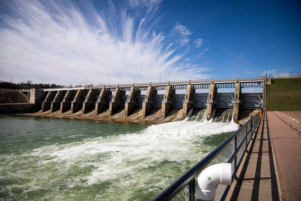 Gavins Point Dam spillway and powerhouse are photographed April 9, 2025. The Gavins Point Dam and Lewis & Clark Lake (the reservoir behind the dam) straddle the Nebraska/South Dakota border and are nestled in the chalkstone-lined valley of the Missouri River and has grown into one of the most popular recreation spots in the Great Plains. The dam consists of an earthen embankment, a powerhouse, and 14 gates on a concrete-lined spillway. During normal operations, USACE releases water through the powerhouse to generate power and balance reservoir levels for other uses.