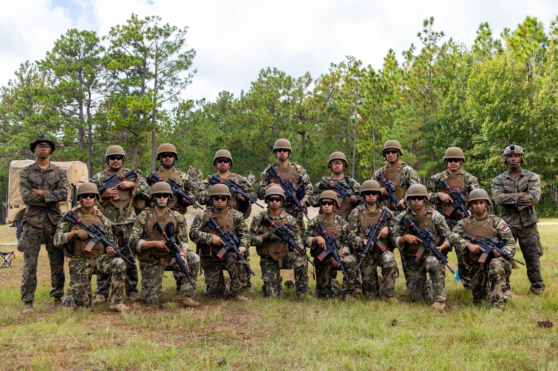 Marines with Comando de Infanteria de Marina Armada Paraguay (Paraguayan marines) pose for a group photo between U.S. Marines with Golf Company, 2nd Battalion, 2nd Marine Regiment, during a multinational marksmanship range as part of exercise UNITAS 2025 at Marine Corps Base Camp Lejeune, North Carolina, Sept. 23, 2025. UNITAS, which is Latin for “unity,” was conceived in 1959 and has taken place annually since first conducted in 1960. This marks the 66th iteration of the world’s longest running annual multinational maritime exercise. (U.S. Marine Corps photo by Lance Cpl. Jack Labrador)